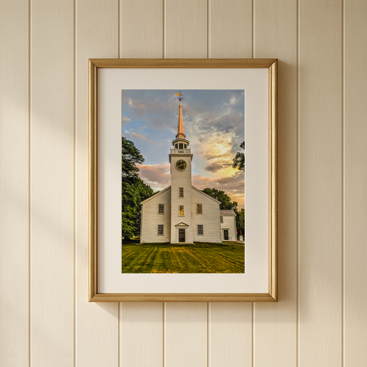 Classic white New England church photograph taken at sunset in Cohasset, Massachusetts shown framed on a wall