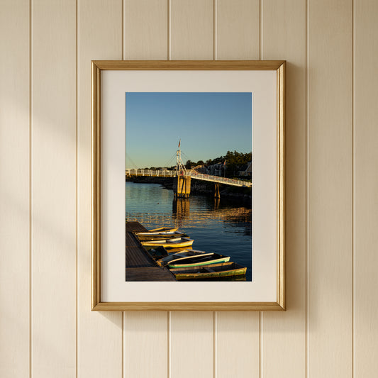 Photo of boats during golden hour in Perkins Cove, Ogunquit, Maine shown framed on a wall