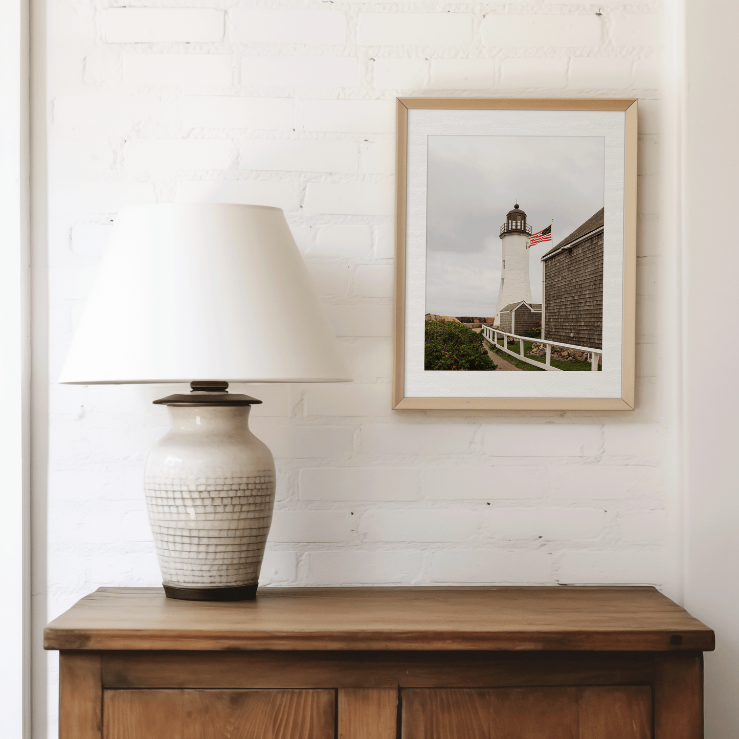 Framed photo of the Scituate Lighthouse in Massachusetts over a cabinet in a living room