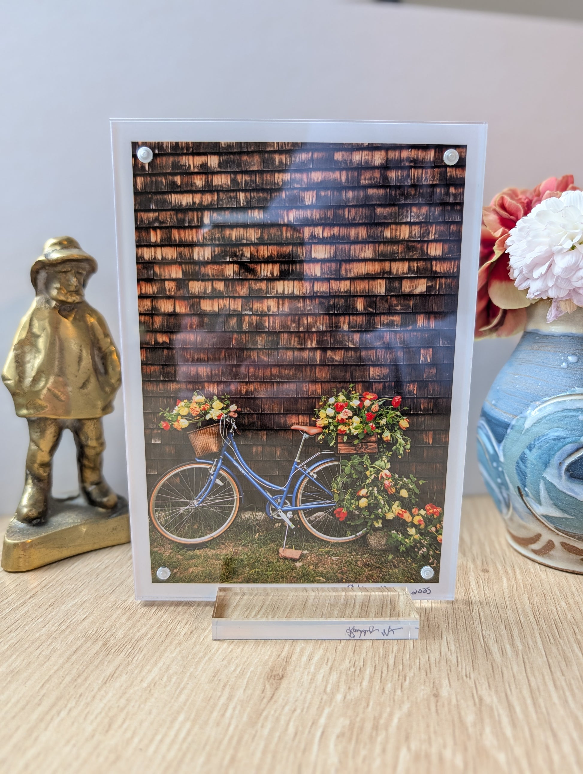 5x7 acrylic framed print of a floral bike displayed on desk, modern office decor