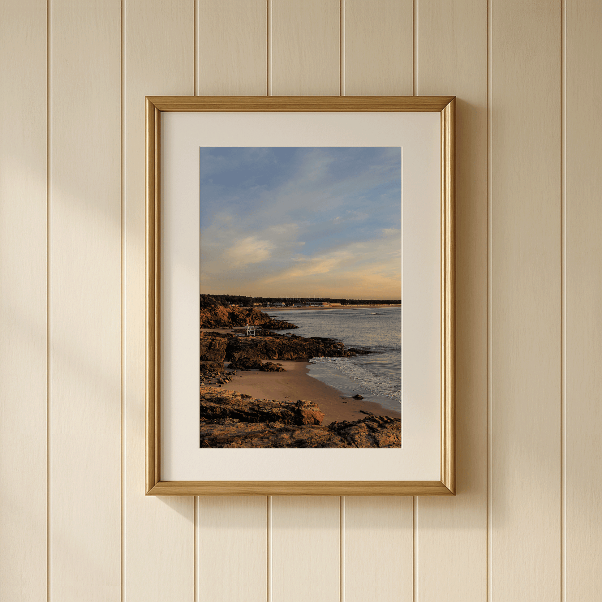 Framed photograph on wall showing a coastal scene from Ogunquit, Maine's Marginal Way