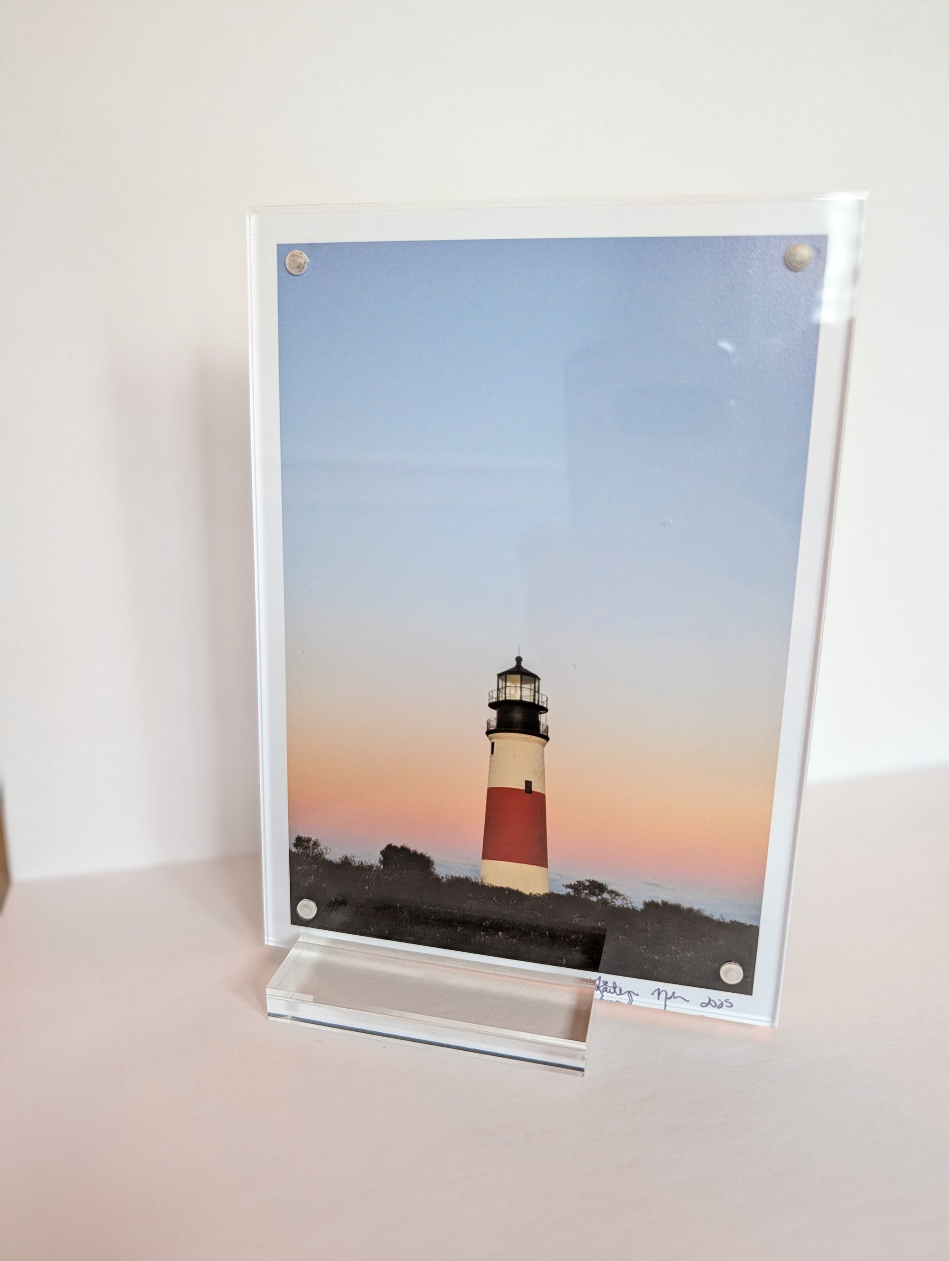 Acrylic block photo print on bookshelf with coastal New England photography