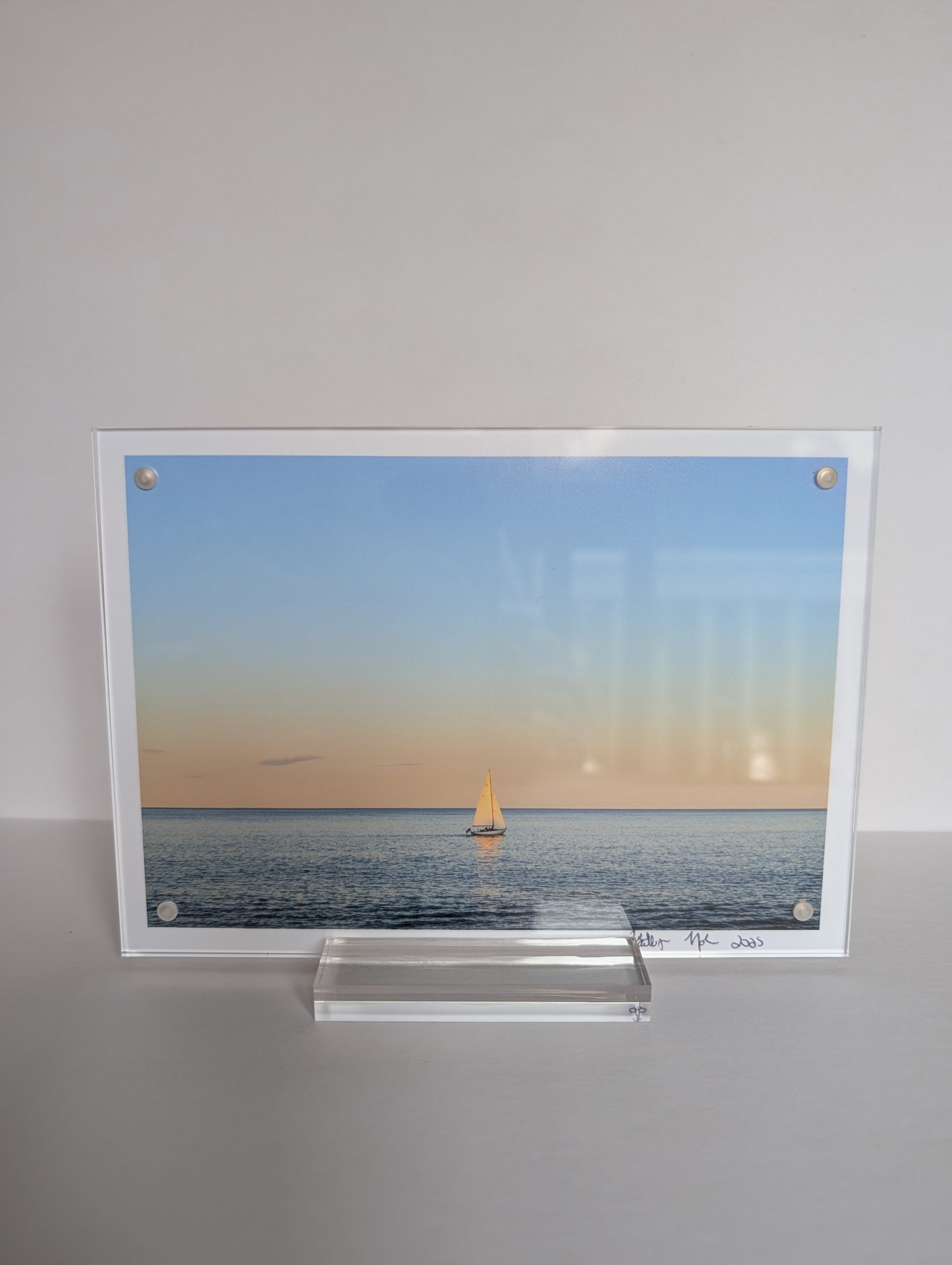 Acrylic block photo print on bookshelf with coastal New England photography