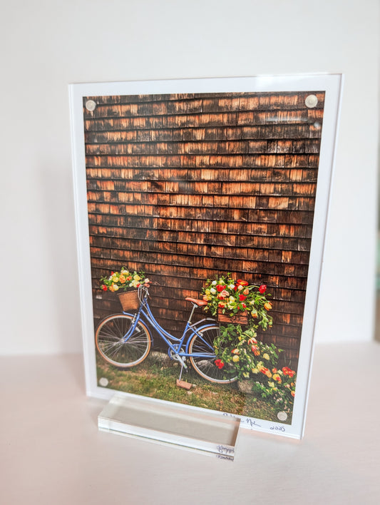 Acrylic block photo print on bookshelf with coastal New England photography